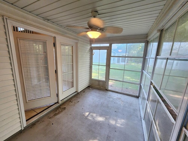 unfurnished sunroom with ceiling fan