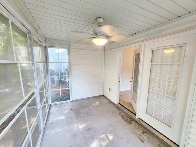 unfurnished sunroom with ceiling fan