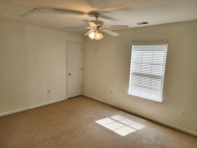 spare room with carpet and ceiling fan