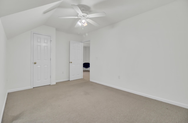 additional living space featuring light carpet, ceiling fan, and lofted ceiling