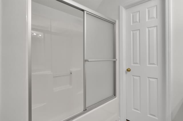 bathroom with shower / bath combination with glass door