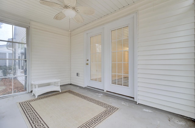 unfurnished sunroom featuring ceiling fan