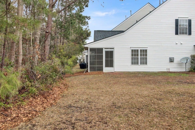 rear view of house featuring a sunroom