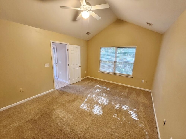 unfurnished bedroom featuring carpet, ceiling fan, and vaulted ceiling