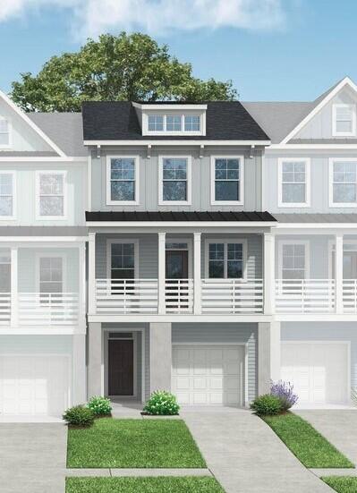 view of front facade with driveway, an attached garage, and board and batten siding