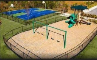 view of basketball court with a playground and a yard