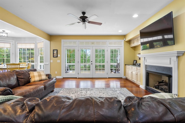 living room featuring french doors, light hardwood / wood-style floors, and ceiling fan