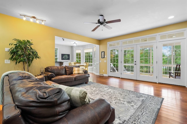 living room with hardwood / wood-style flooring, ceiling fan, and french doors