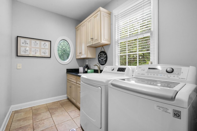 laundry room with sink, cabinets, washing machine and clothes dryer, and light tile patterned floors