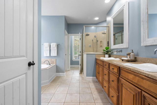 bathroom with tile patterned flooring, shower with separate bathtub, and vanity