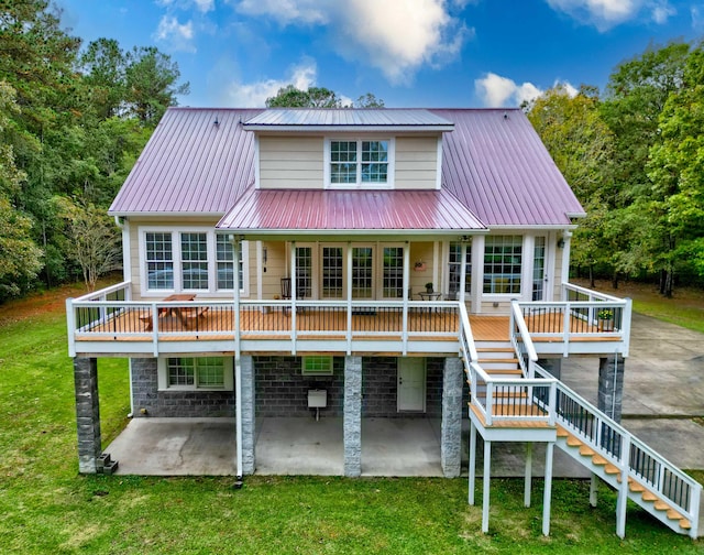 back of property with a patio, a yard, and a wooden deck