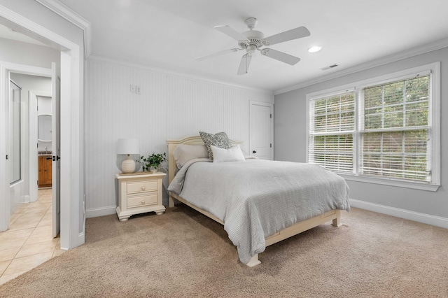 bedroom with ornamental molding, light colored carpet, and ceiling fan