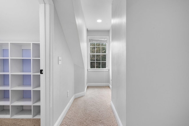 hallway featuring light carpet