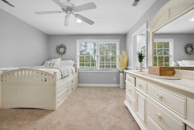 carpeted bedroom with multiple windows and ceiling fan