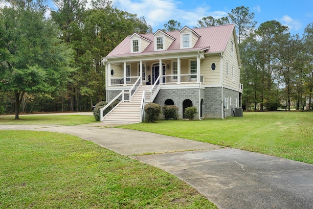 view of front of house with a porch, a front yard, and central AC