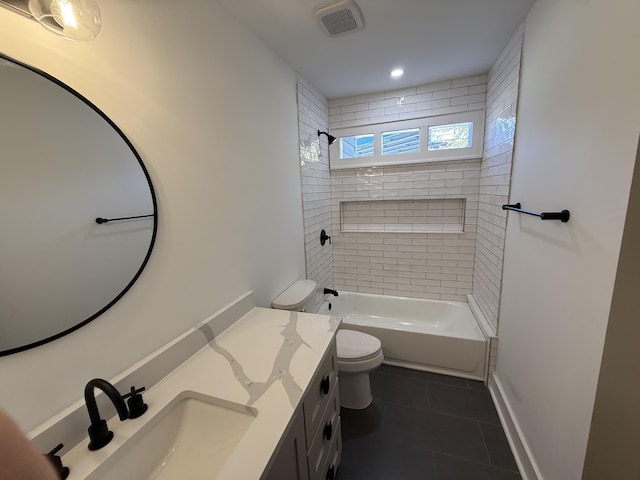 full bathroom with tile patterned flooring, vanity, tiled shower / bath combo, and toilet