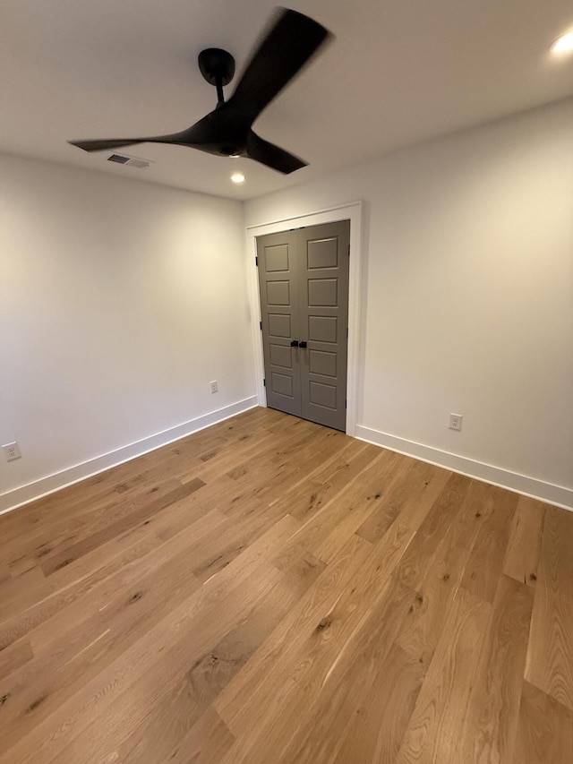 unfurnished bedroom featuring ceiling fan and light wood-type flooring