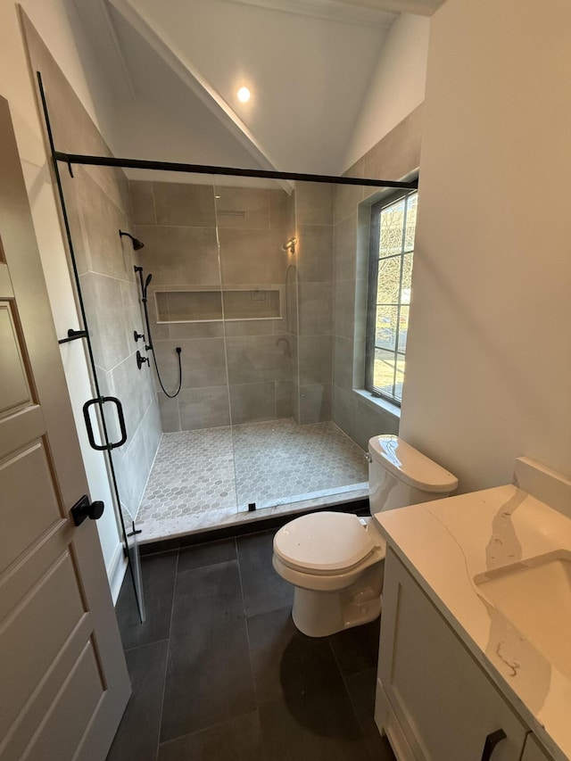 bathroom featuring lofted ceiling, a shower with door, tile patterned flooring, vanity, and toilet