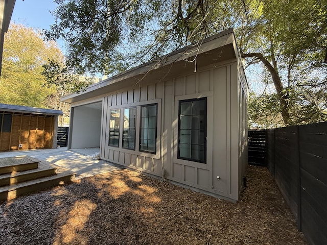 back of house featuring an outbuilding