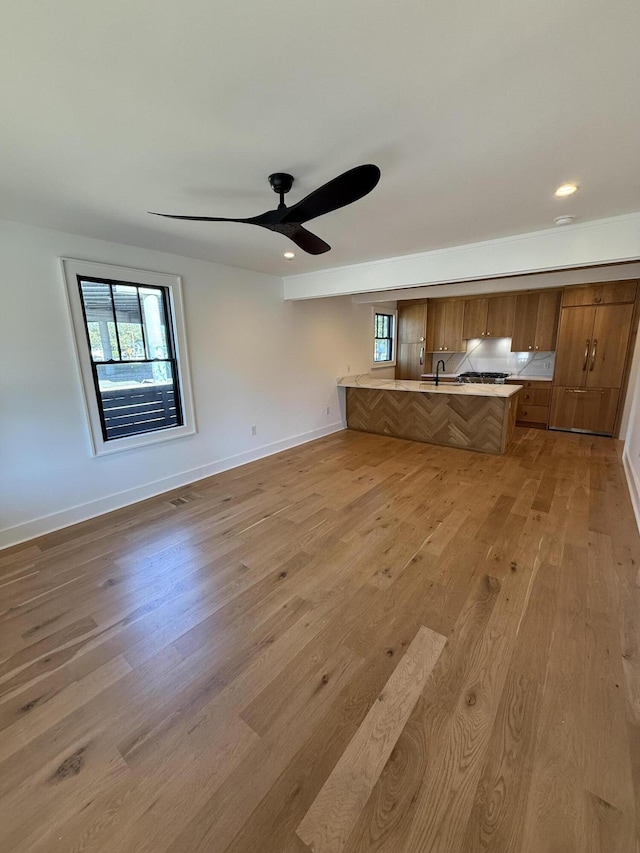 interior space featuring ceiling fan, a healthy amount of sunlight, sink, and light hardwood / wood-style floors