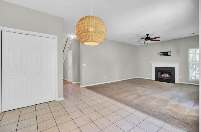 434 Antebellum Ln, Mount Pleasant, SC 29464 - unfurnished living room with a ceiling fan, stairs, a fireplace with flush hearth, and baseboards