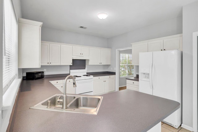 434 Antebellum Ln, Mount Pleasant, SC 29464 - kitchen featuring white appliances, a sink, under cabinet range hood, dark countertops, and white cabinets