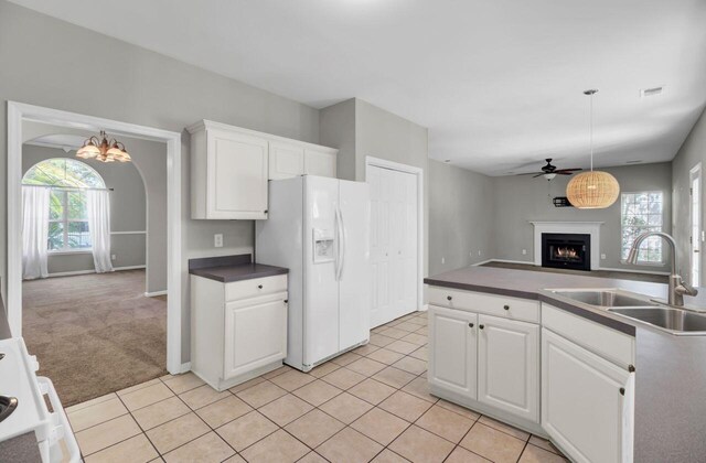 434 Antebellum Ln, Mount Pleasant, SC 29464 - kitchen with white refrigerator with ice dispenser, a sink, a warm lit fireplace, ceiling fan, and open floor plan