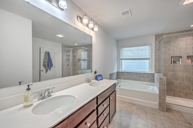 bathroom featuring tile patterned flooring, vanity, and independent shower and bath