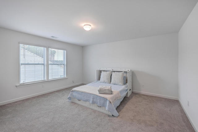 bedroom featuring light colored carpet