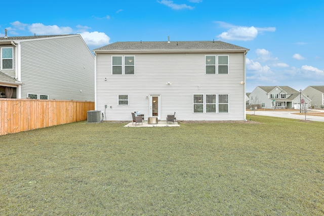 rear view of property featuring cooling unit, a yard, and a patio area