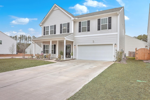 view of front of property with a garage, a porch, and a front yard