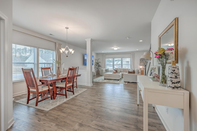 dining room featuring an inviting chandelier and light hardwood / wood-style floors