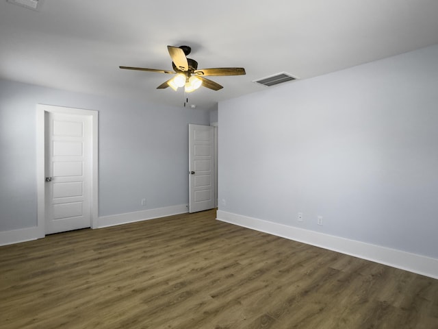 unfurnished room with dark hardwood / wood-style floors and ceiling fan