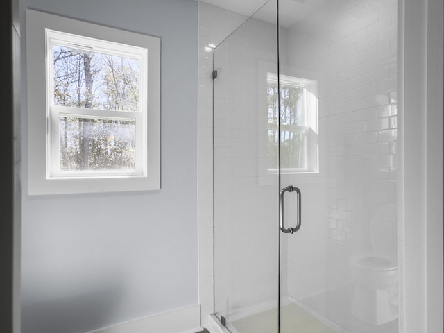 bathroom featuring a shower with shower door