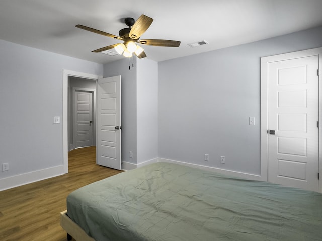 bedroom featuring ceiling fan and hardwood / wood-style floors