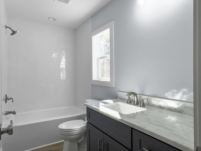 full bathroom featuring vanity, hardwood / wood-style flooring,  shower combination, and toilet