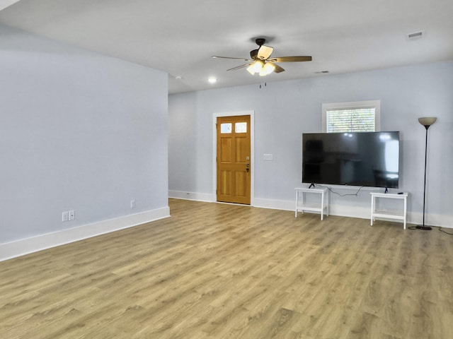 unfurnished living room with ceiling fan and light hardwood / wood-style flooring