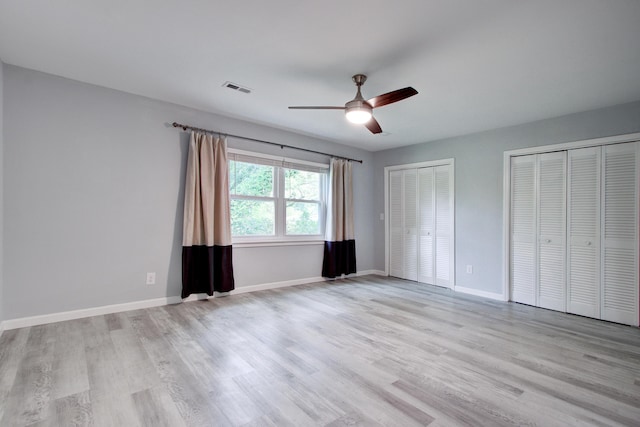 5043 Victoria Ave, North Charleston, SC 29405 - unfurnished bedroom featuring multiple closets, light wood-type flooring, baseboards, and ceiling fan