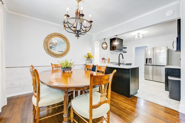 5043 Victoria Ave, North Charleston, SC 29405 - dining space featuring crown molding, a chandelier, wood finished floors, and baseboards