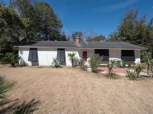 ranch-style house featuring brick siding