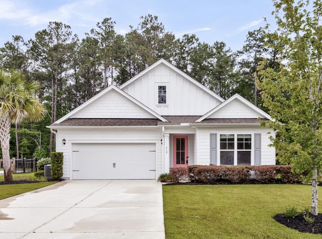 512 Pontoon Rd, Huger, SC 29450 - view of front facade featuring an attached garage, driveway, a front lawn, board and batten siding, and central AC
