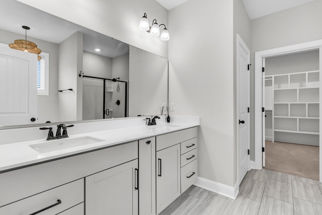 512 Pontoon Rd, Huger, SC 29450 - bathroom featuring a shower stall, double vanity, baseboards, and a spacious closet