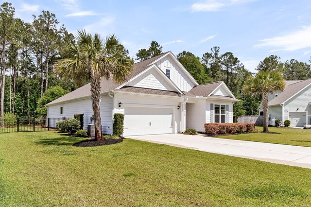 512 Pontoon Rd, Huger, SC 29450 - view of front of home with an attached garage, board and batten siding, driveway, and a shingled roof