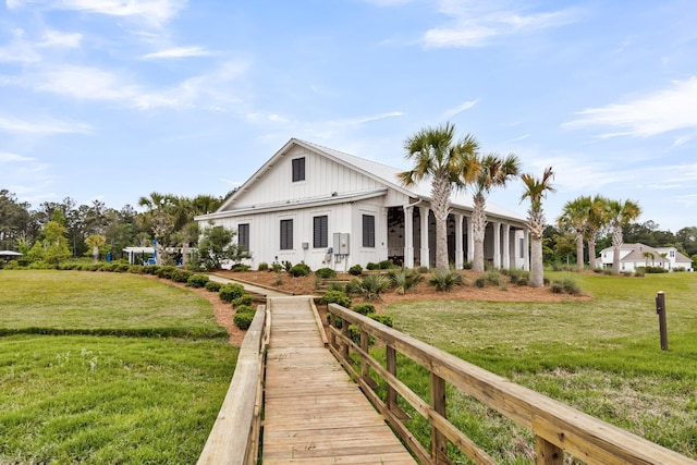 512 Pontoon Rd, Huger, SC 29450 - rear view of house featuring board and batten siding and a yard