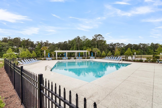 512 Pontoon Rd, Huger, SC 29450 - community pool with fence, a patio area, a pergola, and view of wooded area