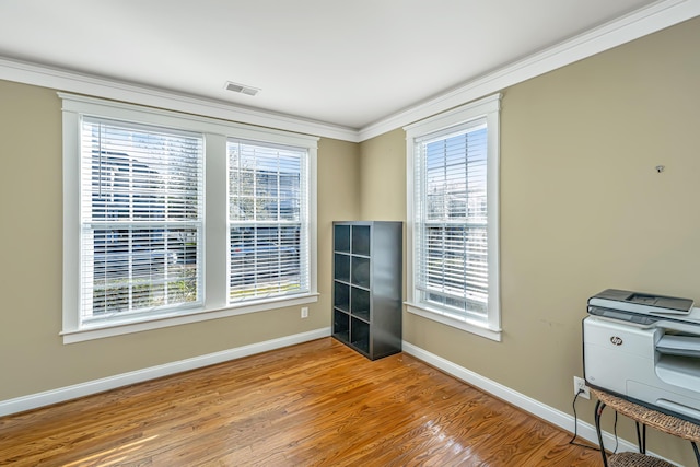 empty room featuring light hardwood / wood-style floors and ornamental molding