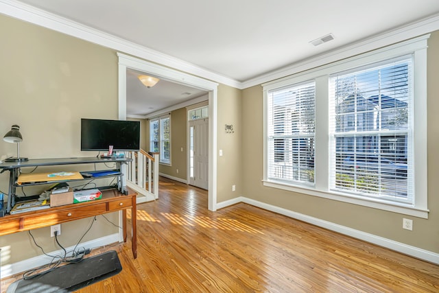 home office with light wood-type flooring and crown molding