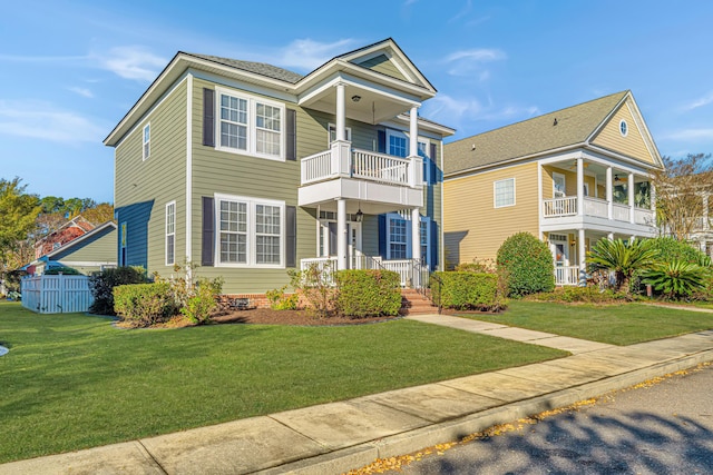 view of front of house with a balcony, a front lawn, and a porch