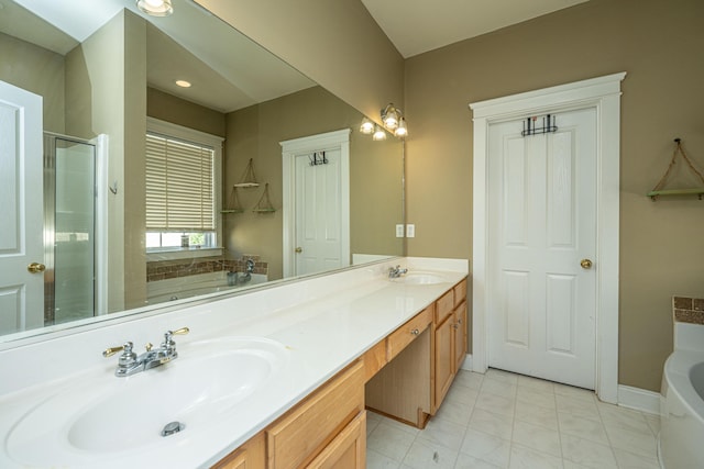 bathroom featuring plus walk in shower, vanity, and tile patterned floors