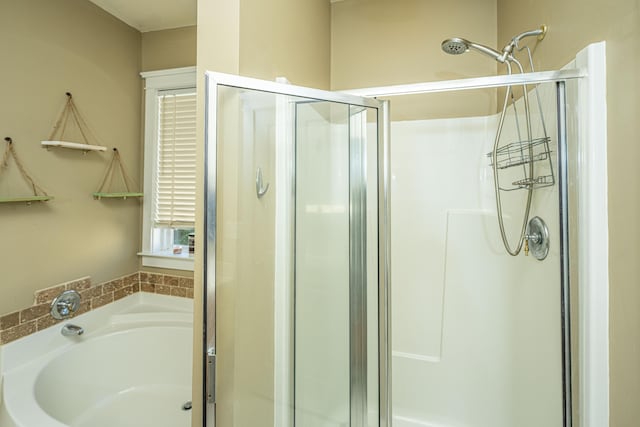 bathroom featuring independent shower and bath